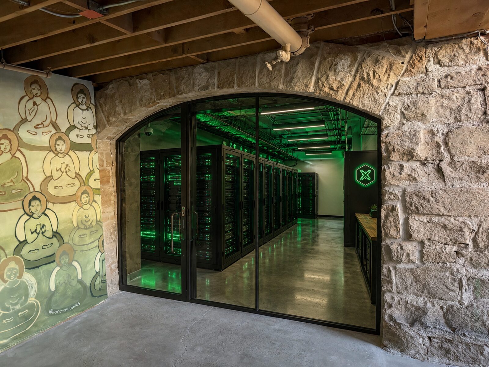 Secure data room with green-lit server racks behind glass